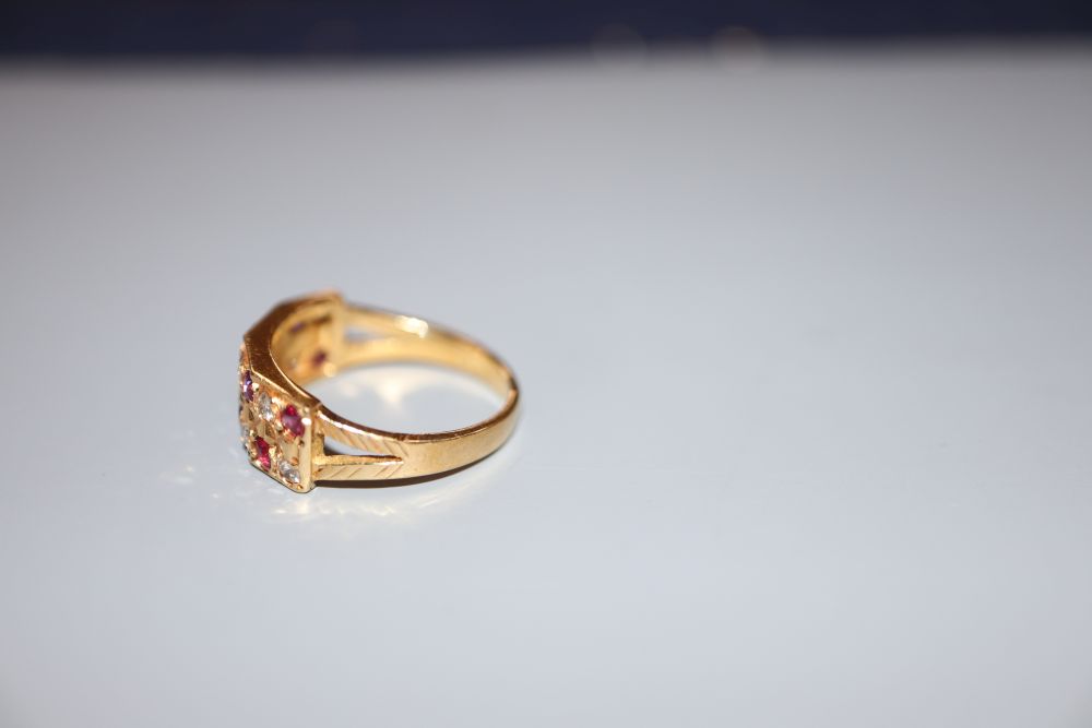 A modern 18ct, eight stone ruby and eight stone diamond set half hoop dress ring, size L/M, gross 3.7 grams.